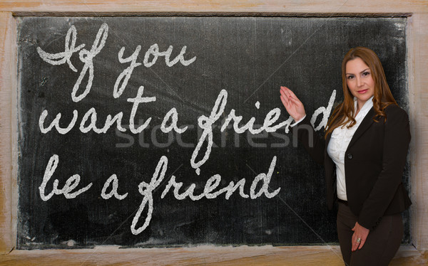 Teacher showing If you want a friend, be a friend on blackboard Stock photo © vepar5