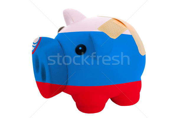 closed piggy rich bank with bandage in colors national flag of s Stock photo © vepar5