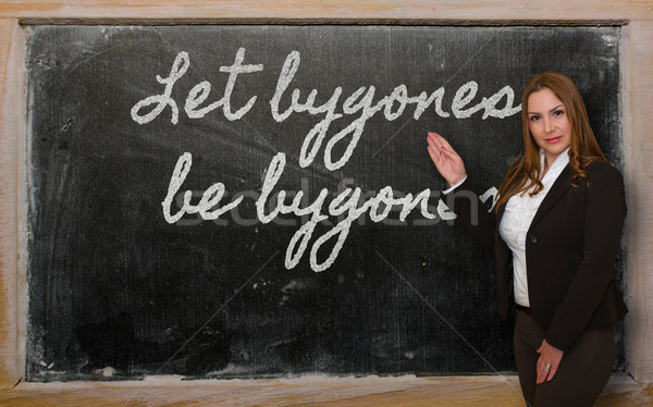 Teacher showing Let bygones be bygones on blackboard Stock photo © vepar5