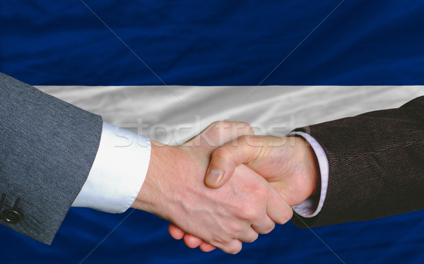 businessmen handshake after good deal in front of nicaragua flag Stock photo © vepar5