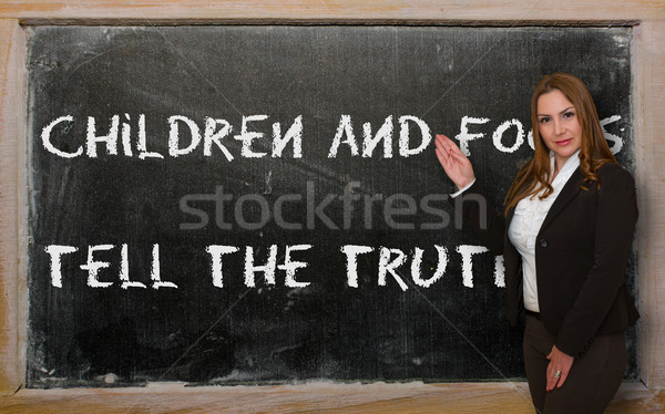 Teacher showing Children and fools tell the truth on blackboard Stock photo © vepar5
