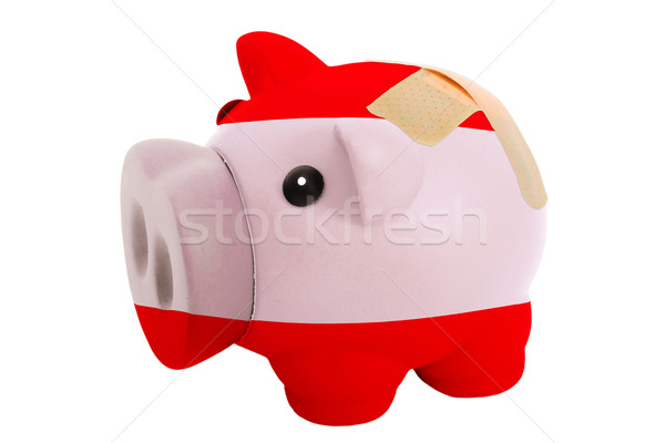 closed piggy rich bank with bandage in colors national flag of a Stock photo © vepar5