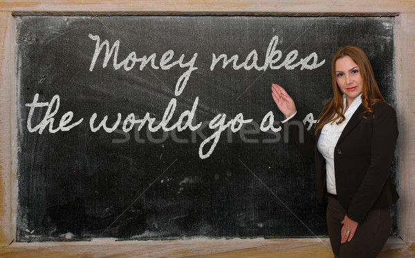 Teacher showing Money makes the world go around on blackboard Stock photo © vepar5