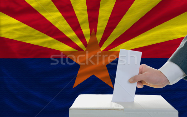 man voting on elections in front of flag US state flag of arizon Stock photo © vepar5