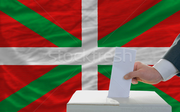 man voting on elections in front of national flag of basque Stock photo © vepar5
