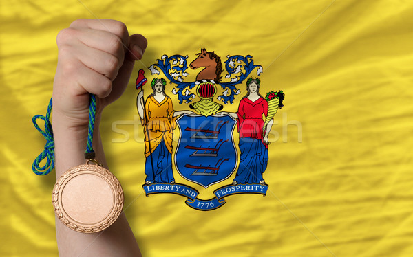 Bronze medal for sport and  flag of american state of new jersey Stock photo © vepar5