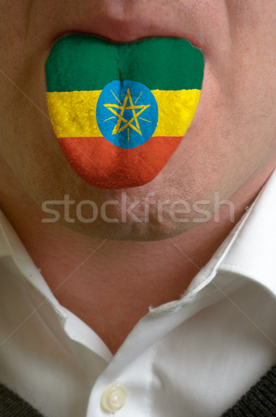 man tongue painted in ethiopia flag symbolizing to knowledge to  Stock photo © vepar5