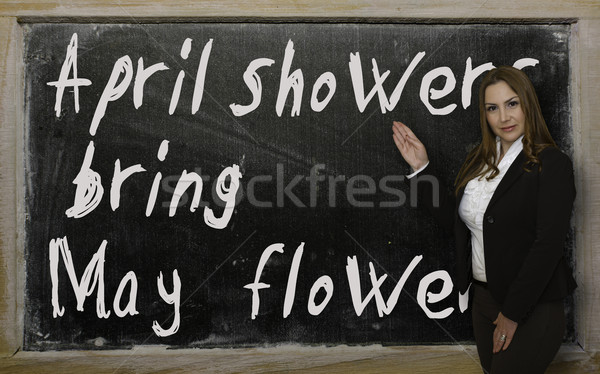 Teacher showing April showers bring May flowers on blackboard Stock photo © vepar5