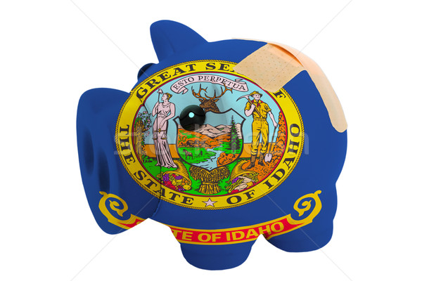 closed piggy rich bank with bandage in colors flag of american s Stock photo © vepar5