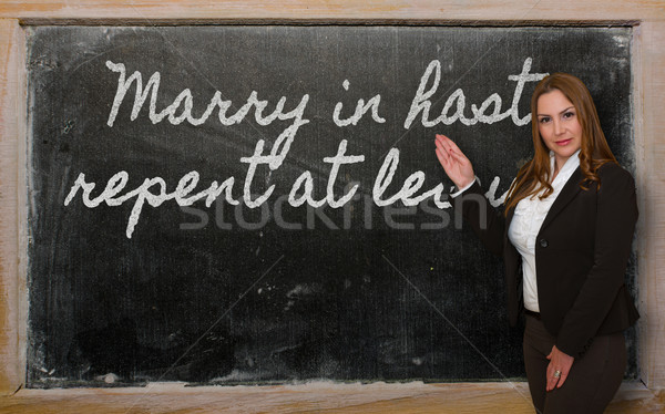 Teacher showing Marry in haste, repent at leisure on blackboard Stock photo © vepar5