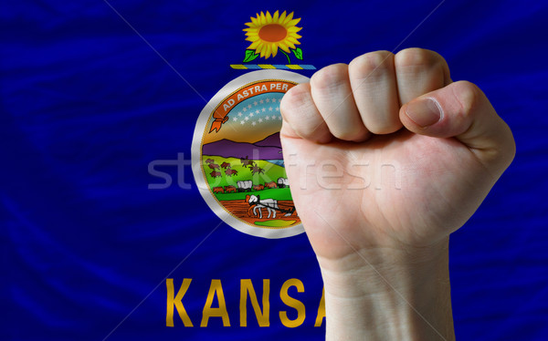 us state flag of kansas with hard fist in front of it symbolizin Stock photo © vepar5