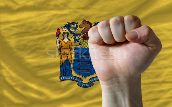 us state flag of new jersey with hard fist in front of it symbol Stock photo © vepar5