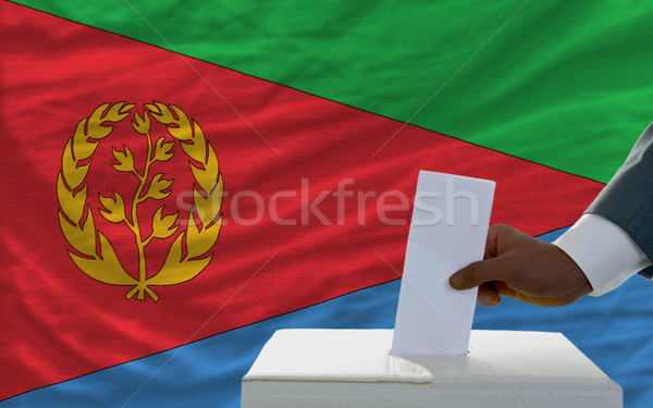 man voting on elections in front of national flag of equatorial  Stock photo © vepar5