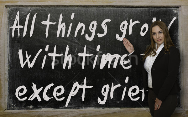 Teacher showing All things grow with time - except grief on blac Stock photo © vepar5