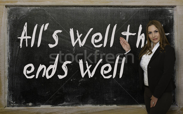 Teacher showing All's well that ends well on blackboard Stock photo © vepar5