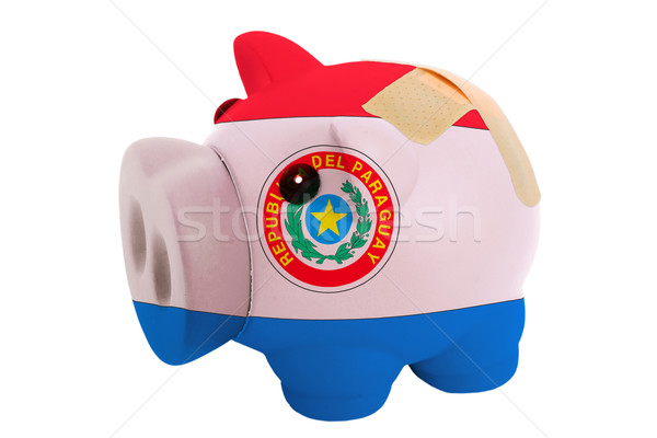 closed piggy rich bank with bandage in colors national flag of p Stock photo © vepar5