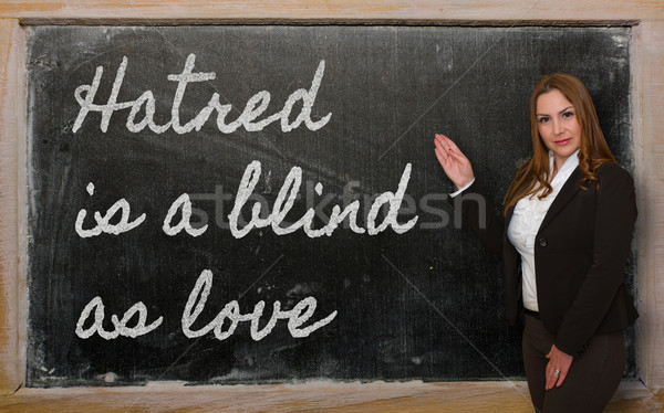 Stock photo: Teacher showing Hatred is a blind as love on blackboard