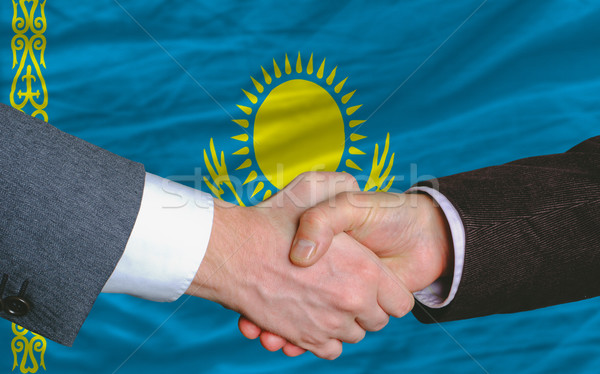 businessmen handshake after good deal in front of kazakhstan fla Stock photo © vepar5