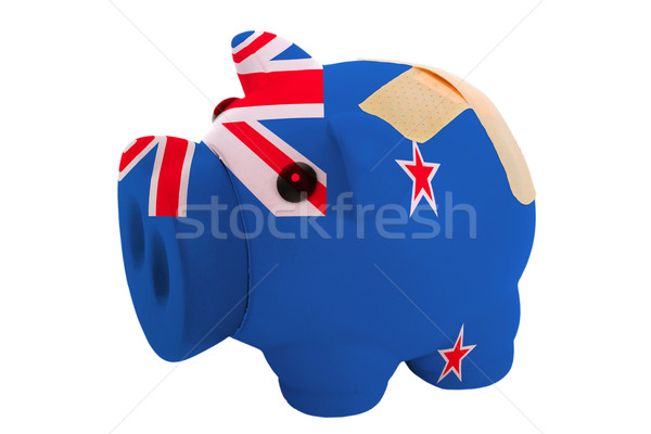 closed piggy rich bank with bandage in colors national flag of n Stock photo © vepar5