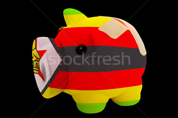 bankrupt piggy rich bank in colors of national flag of zimbabwe  Stock photo © vepar5