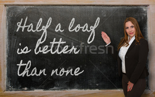 Teacher showing Half a loaf is better than none on blackboard Stock photo © vepar5