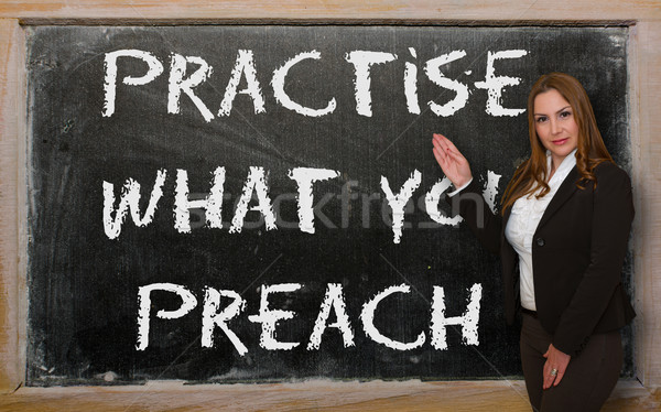Teacher showing Practise what you preach on blackboard Stock photo © vepar5