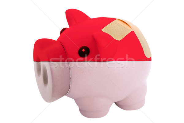 closed piggy rich bank with bandage in colors national flag of i Stock photo © vepar5