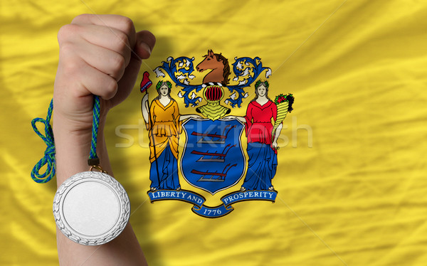Silver medal for sport and  flag of american state of new jersey Stock photo © vepar5