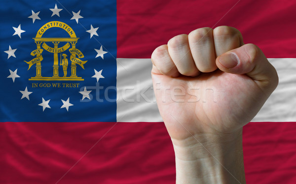us state flag of georgia with hard fist in front of it symbolizi Stock photo © vepar5