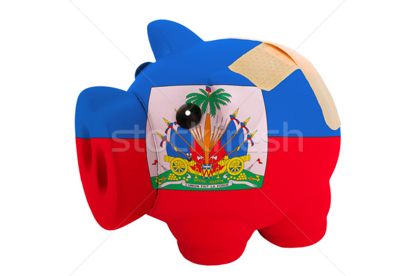 closed piggy rich bank with bandage in colors national flag of h Stock photo © vepar5