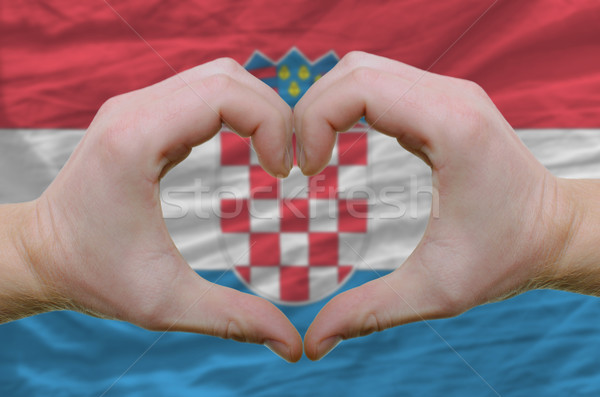 Heart and love gesture showed by hands over flag of Croatia back Stock photo © vepar5