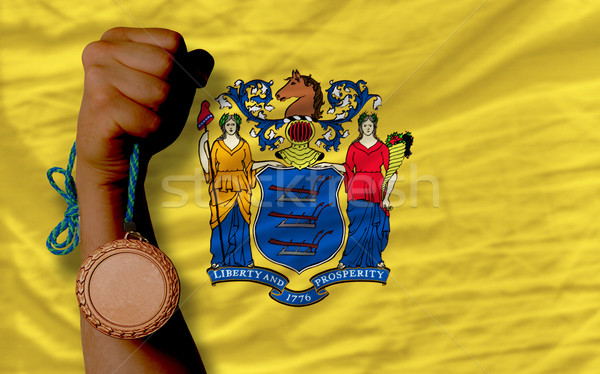 Bronze medal for sport and  flag of american state of new jersey Stock photo © vepar5