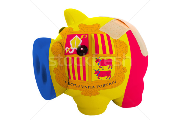 closed piggy rich bank with bandage in colors national flag of a Stock photo © vepar5