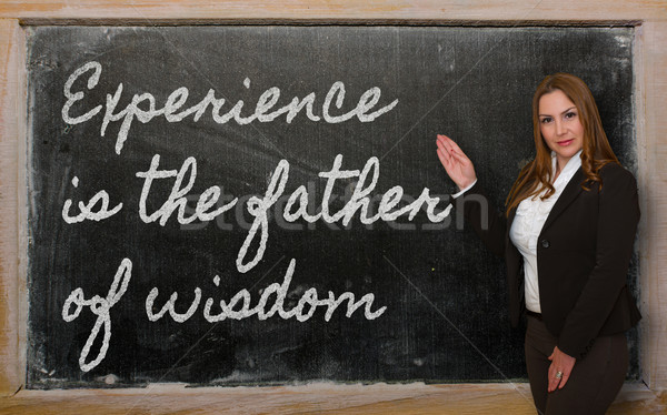 Teacher showing Experience is the father of wisdom on blackboard Stock photo © vepar5