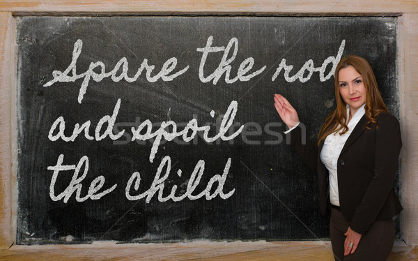 Teacher showing Spare the rod and spoil the child on blackboard Stock photo © vepar5