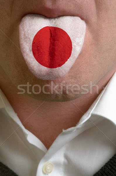 man tongue painted in japan flag symbolizing to knowledge to spe Stock photo © vepar5