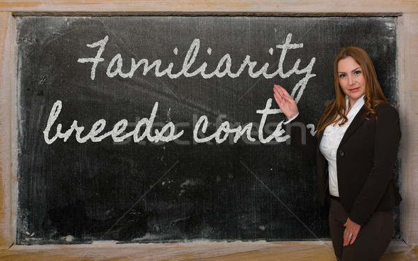 Teacher showing Familiarity breeds contempt  on blackboard Stock photo © vepar5