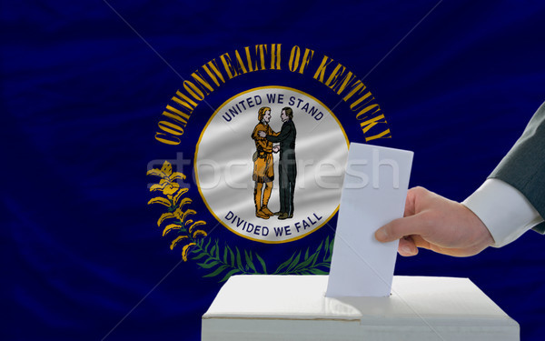 man voting on elections in front of flag US state flag of kentuc Stock photo © vepar5