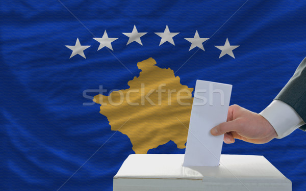 man voting on elections in front of national flag of kosovo Stock photo © vepar5