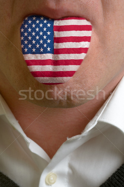 man tongue painted in usa flag symbolizing to knowledge to speak Stock photo © vepar5