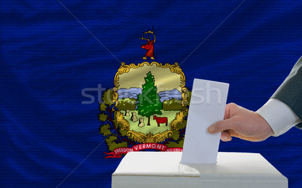 man voting on elections in front of flag US state flag of vermon Stock photo © vepar5