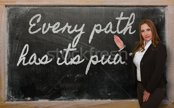 Teacher showing Every path has its puddle on blackboard Stock photo © vepar5