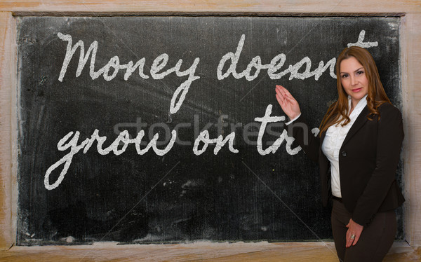 Teacher showing Money doesn t grow on trees on blackboard Stock photo © vepar5