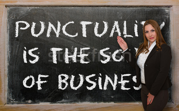 Teacher showing Punctuality is the soul of business on blackboar Stock photo © vepar5