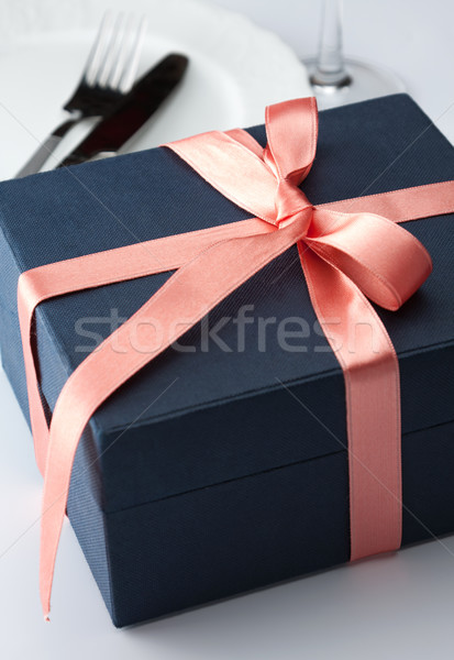 Gift box in a decorative red ribbon Stock photo © veralub