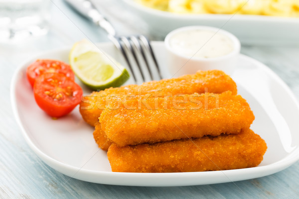 Stock photo: Fish fingers and potato salad