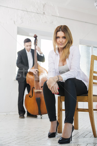 Woman on chair and man plays melody Stock photo © vetdoctor