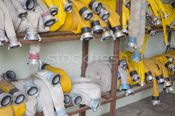Yellow firehose are hanging on warehouse shelfs Stock photo © vetdoctor