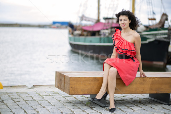 Woman in red dress posing at harbor Stock photo © vetdoctor