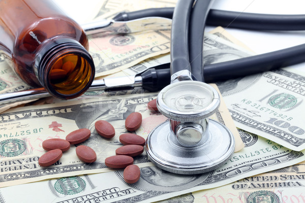 Stethoscope and Pills on dollars Stock photo © vichie81